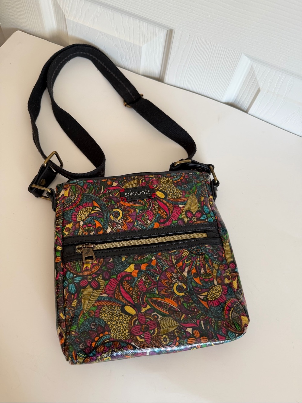 Sakroots Artist Circle Crossbody Bag. Vibrant multicolor floral and paisley.Read